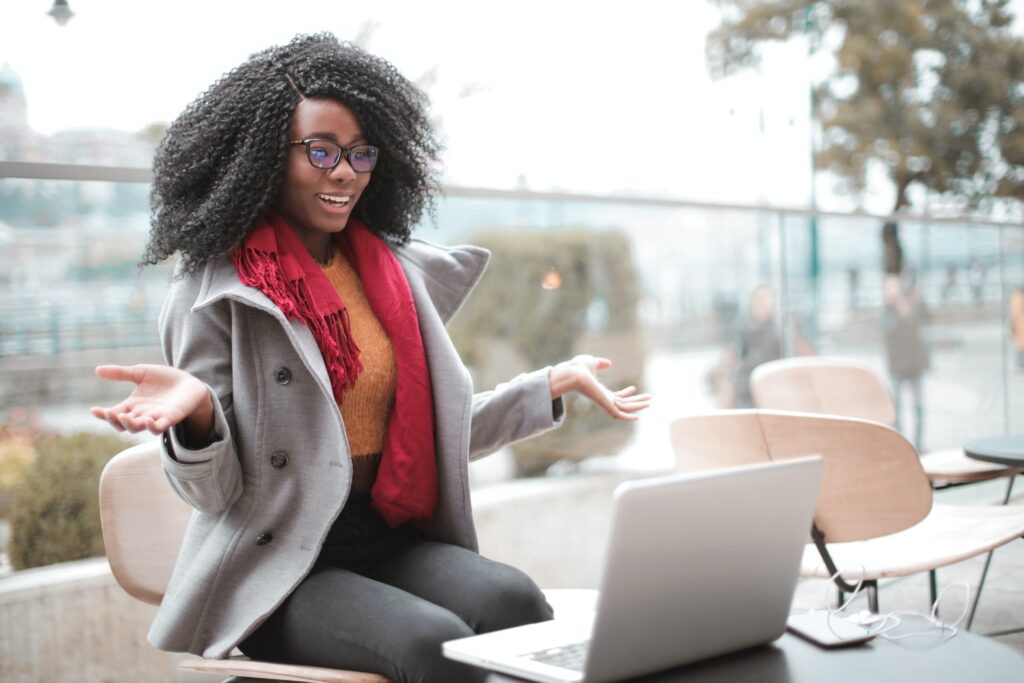 cheerful-surprised-woman-sitting-with-laptop-3762940-5ebb03feac778