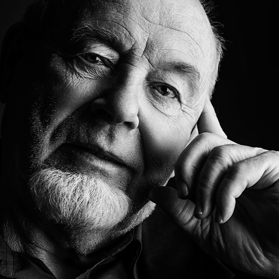 man with hand on his head looking at the camera